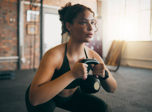 istock Exercise, kettlebell and a woman at gym breathing during workout, exercise and weight training for body wellness. Strong sports female or athlete with weights for power, muscle and healthy lifestyle 1473685102
