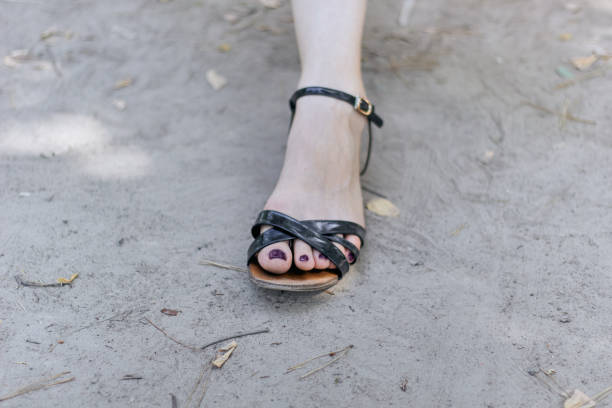istock Feet with painted nails in black sandal. 1473685137