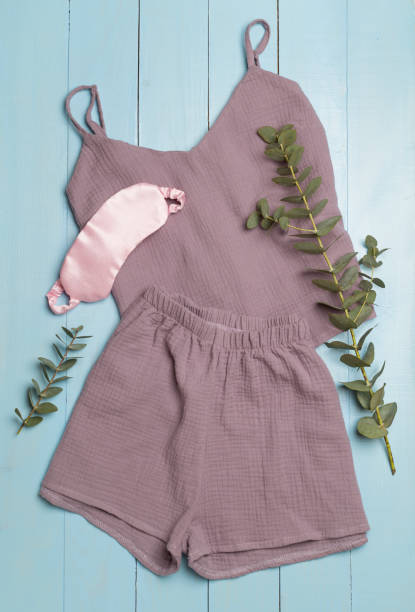 istock Flat lay composition with beautiful pajamas on wooden background, top view 1473685433