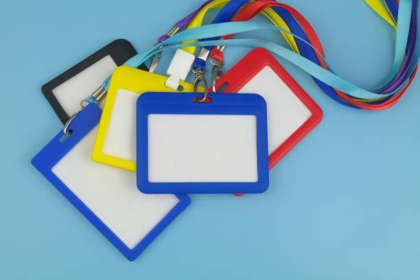 istock Heap of many blank badges with ropes on blue background. 1473686427