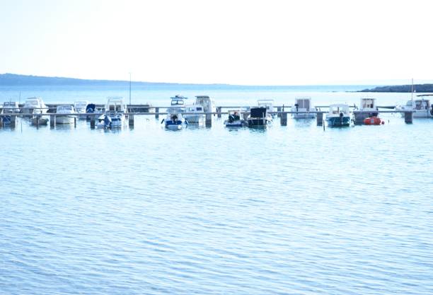boats tied to the shore on the Adriatic coast, Croatia, winter, late afternoon