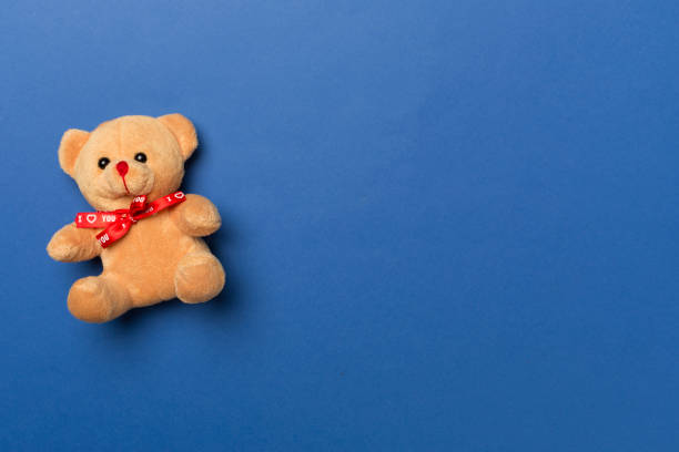 istock Cute teddy bear on color background, top view 1473687715