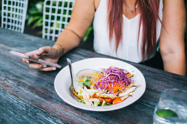 istock Crop young stylish woman using smartphone during lunch break 1473687798