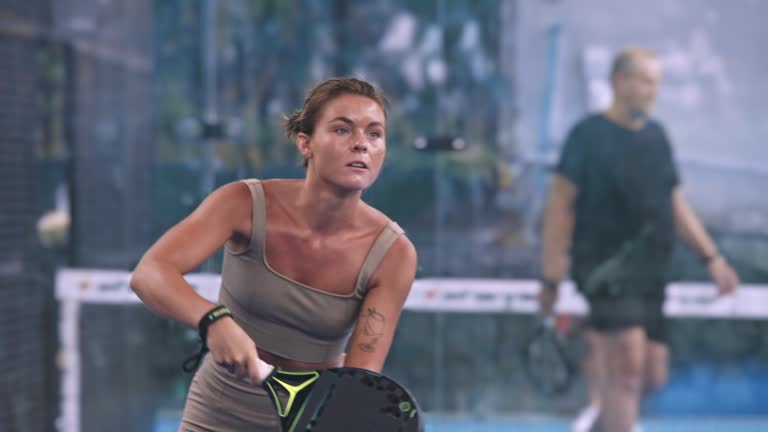 Girl hit ball closeup. Woman racket serve slowmotion. Female padel player tennis