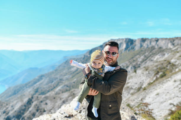 istock Father Taking Baby For A Walk In Nature 1473689264