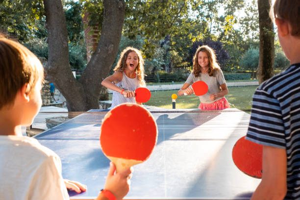 istock Children playing table tennis on summer day 1473689285