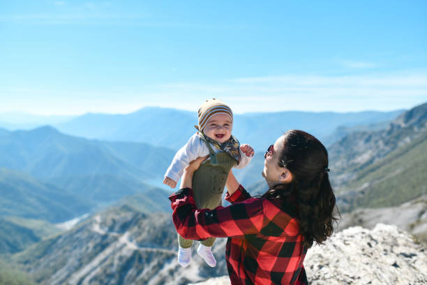 istock Smiling Baby Feeling Relaxed In Nature With Mom 1473689403