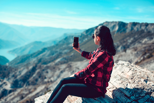 Female Photographing Beautiful View Of Valley With Lake