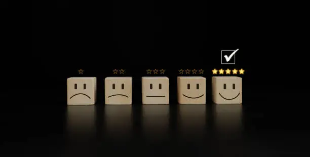 Photo of Chooses a smile face on wood block cube. Satisfaction survey. Questionnaire best excellent business services rating customer experience. five Star good comparison. marketing conceptual.