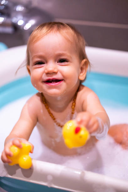 istock Happy baby girl is having a bath 1473689494