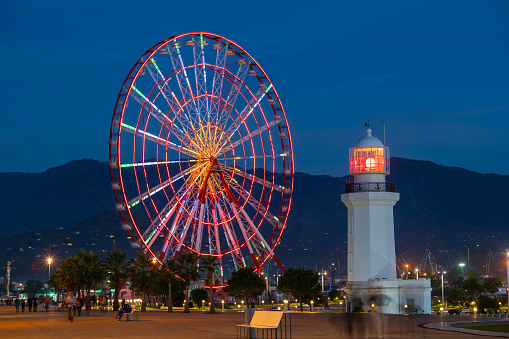Batumi, Georgia - Oct 31, 2018 : The Ferris wheel and lighthouse at night in the center of Batumi, Georgia