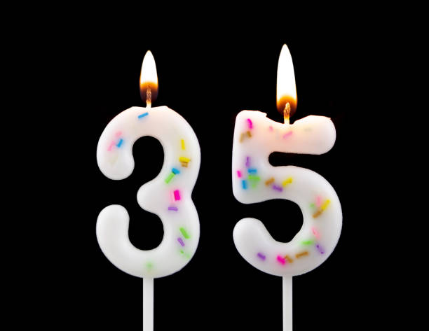 istock Burning birthday candles isolated on black background, number 35 1473693767