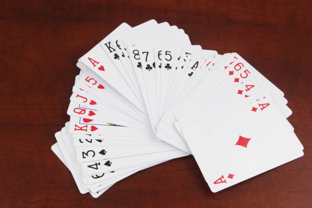 istock Playing cards on wooden table, top view 1473695110