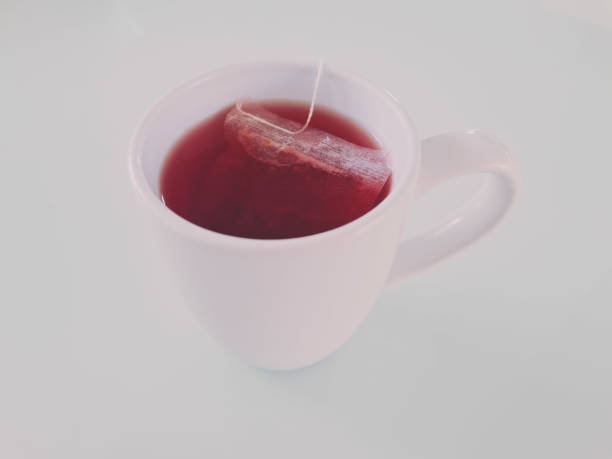 A cup of tea A mug with hibiscus, wild rose and blackberry teabag. Red tea. wild rose hip stock pictures, royalty-free photos & images