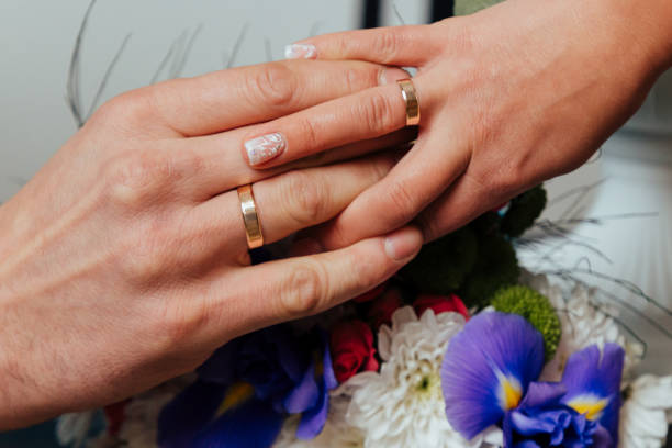 istock bride and groom holding hands 1473696785