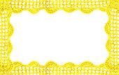 Crocheted yellow lace on a golden background.