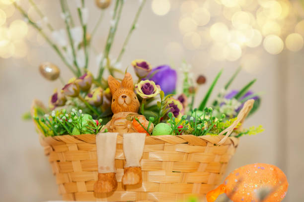 istock Easter basket with decorative eggs, flowers and a rabbit miniature. 1473697575