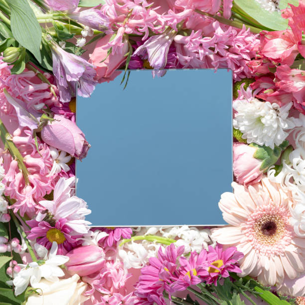 istock Colorful spring flowers in the background with a mirror reflecting the sky. 1473700017