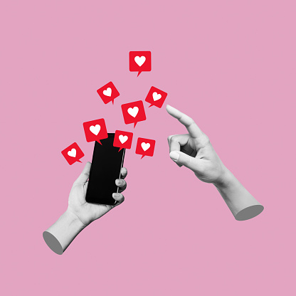 Female hand pointing to like symbols of social networks from mobile phone with black blank screen on pink color background. 3d trendy collage in magazine urban style. Contemporary art. Modern design