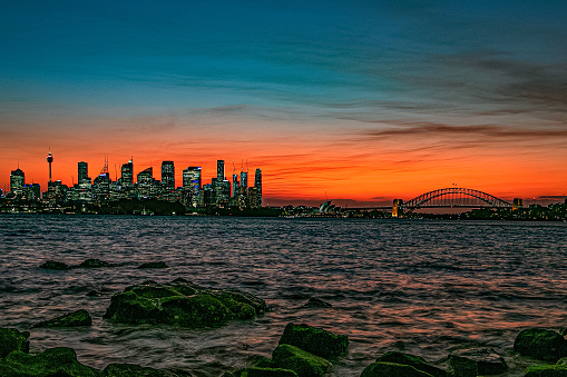 Sydney sunset with opera house and harbour bridge under the orange sky in Australia
