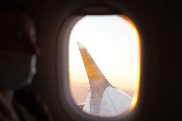 istock View of a plane wing over the ocean from inside the cabin 1473701374