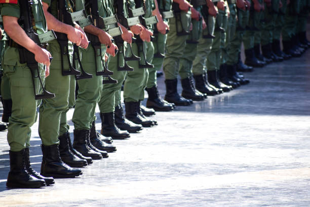 istock Armed militars marching in public full equiped 1473701429