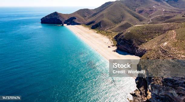 Drone Aerial View Of Seashore Coastline Scenic View Of People At Unspoiled Beach In Almeria Called Playa De Los Muertos Stock Photo - Download Image Now