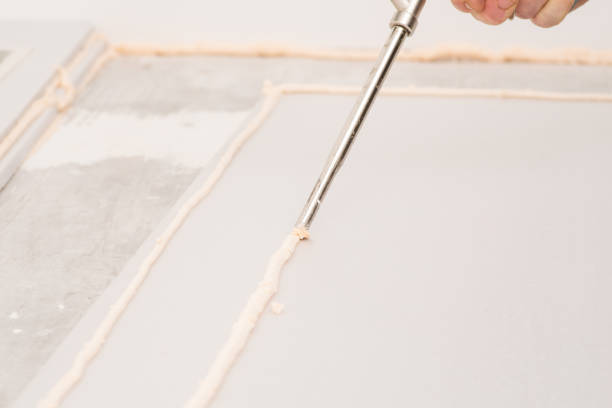 istock Applying gluing foam on sheet of styrofoam 1473704222