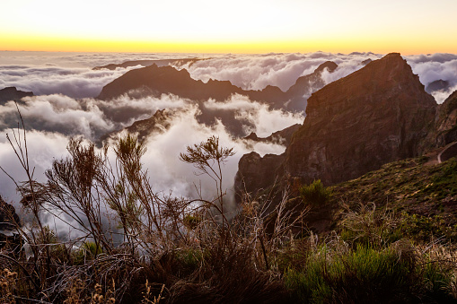 Beautiful valley in the mountains at sunset, clouds below the viewpoint