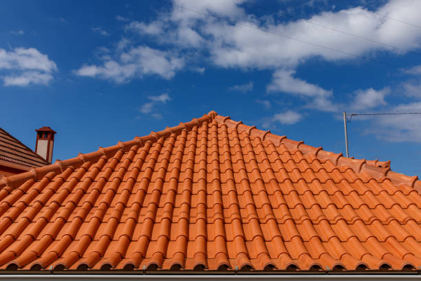 istock Red tiles panels roof under blue sky. 1473705142