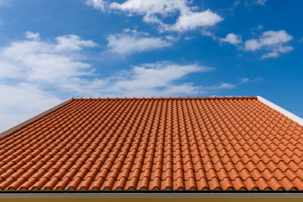 istock Red tiles panels roof under blue sky. 1473705159