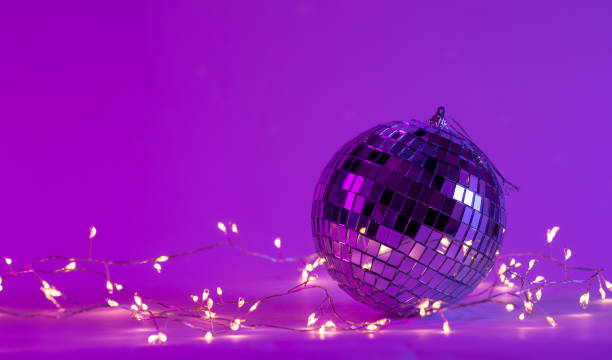 istock Christmas background with disco ball and garland in neon lighting. 1473706225