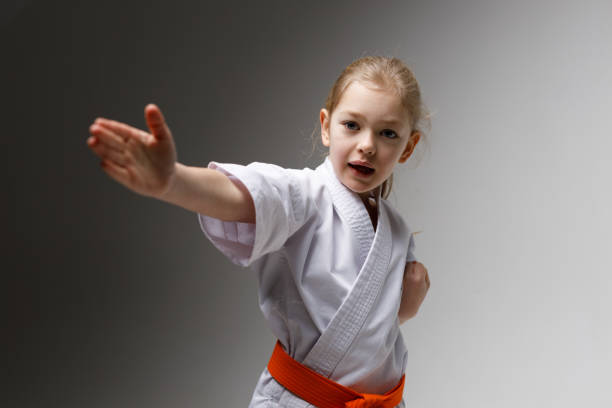 istock A girl in a kimono makes a punch in karate. 1473706385