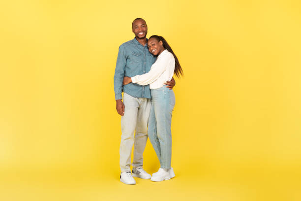 istock Loving Black Spouses Hugging Posing Standing Over Yellow Background 1473707842