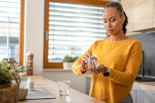 istock Woman pouring pills into hand 1473708373