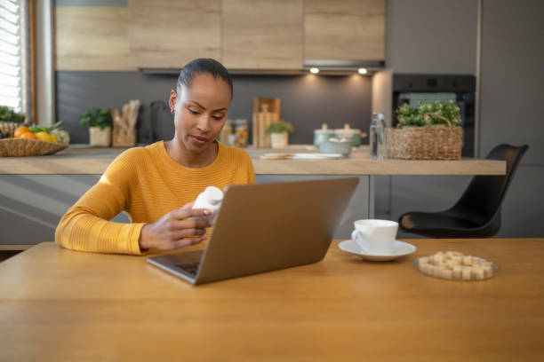 istock Woman looking pill bottle 1473708386