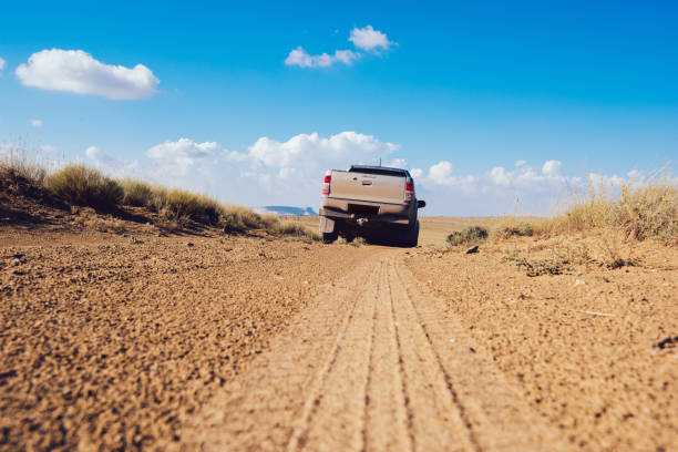 istock Pickup truck driving through countryside road 1473708461