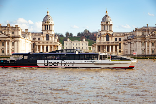 London, UK - 14 March, 2023: an Uber Boat, a river taxi service, carrying passengers on the river Thames in Greenwich, London, UK.