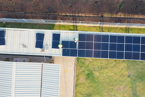 Workers install solar panels at a public corridor on Fangshan West Road, Xiang'an District, Xiamen, Fujian Province, China