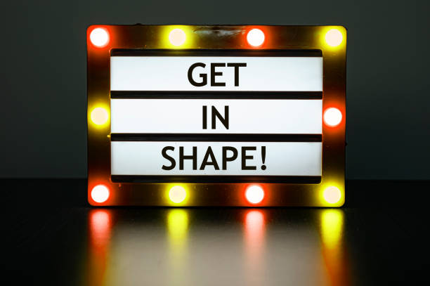 istock Lightbox with red and orange lights in dark room with words - Get in shape! 1473708709