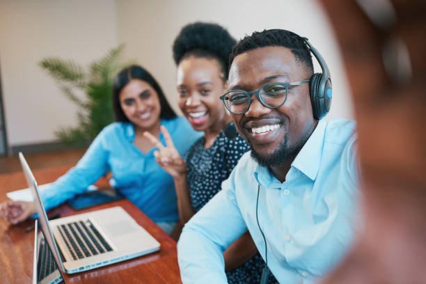 istock Selfie in the office, call centre agents pose and have fun, teamwork success 1473709626
