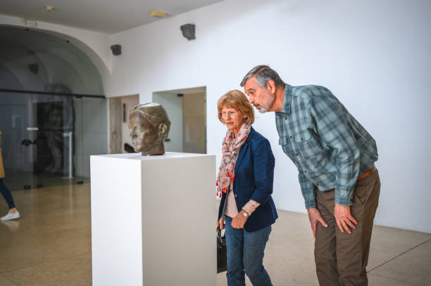 istock Senior Heterosexual Couple Looking at the Museum Label 1473709900