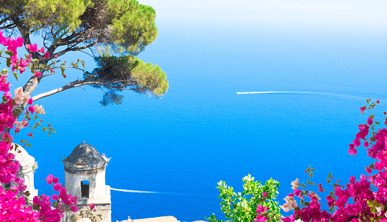 Belltower in Ravello village with sea view with flowers, Amalfi coast of Italy