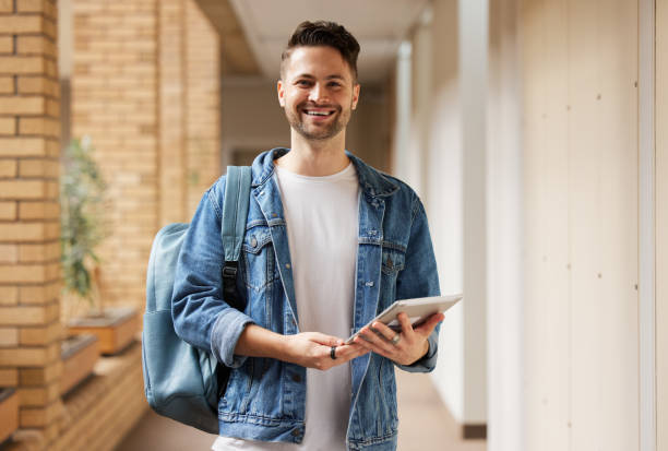 istock University portrait and man student with tablet for academic learning, research and studying online. Education, knowledge and Gen Z college learner at campus on break in California, USA. 1473711047