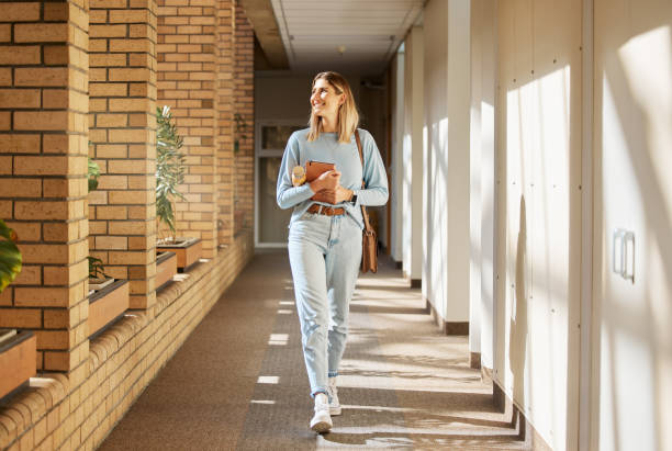 istock Education, scholarship and woman at college for learning, knowledge and studying for future on campus. University, happy and student with idea for higher education at an academy thinking with a smile 1473711566