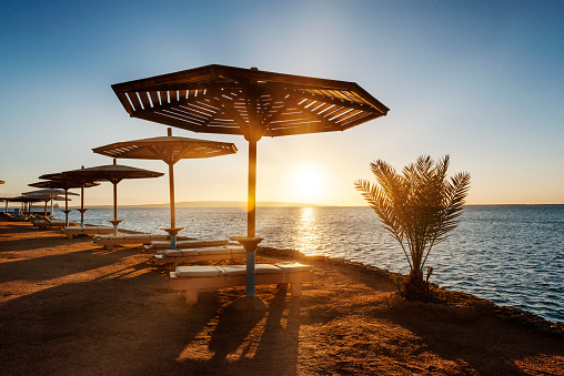 Amazing sunrise on an empty beach, a resort on the Red Sea