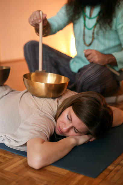 istock Man playing a rin gong during a sound therapy 1473714335