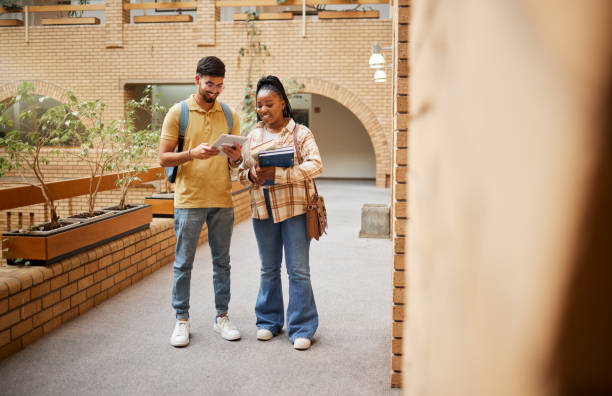 istock Students, university and education, tablet and books for learning, scholarship and collaboration on campus. College with man and black woman study together, learn with diversity and academic goals 1473716684