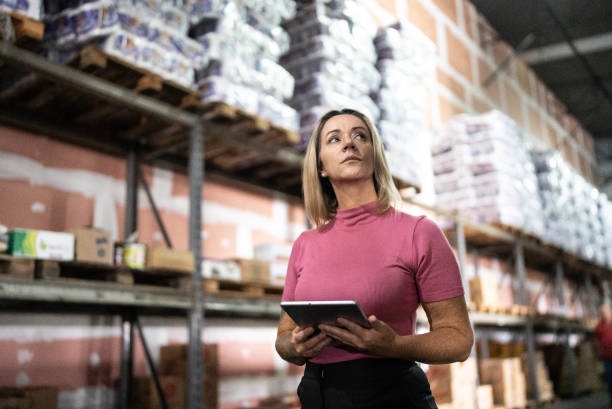 istock Mature woman working on a digital tablet in a warehouse 1473719965