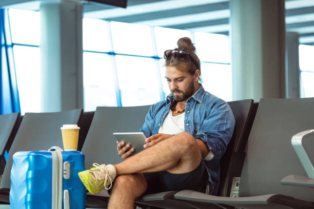 istock Young man waiting for the flight 1473723327